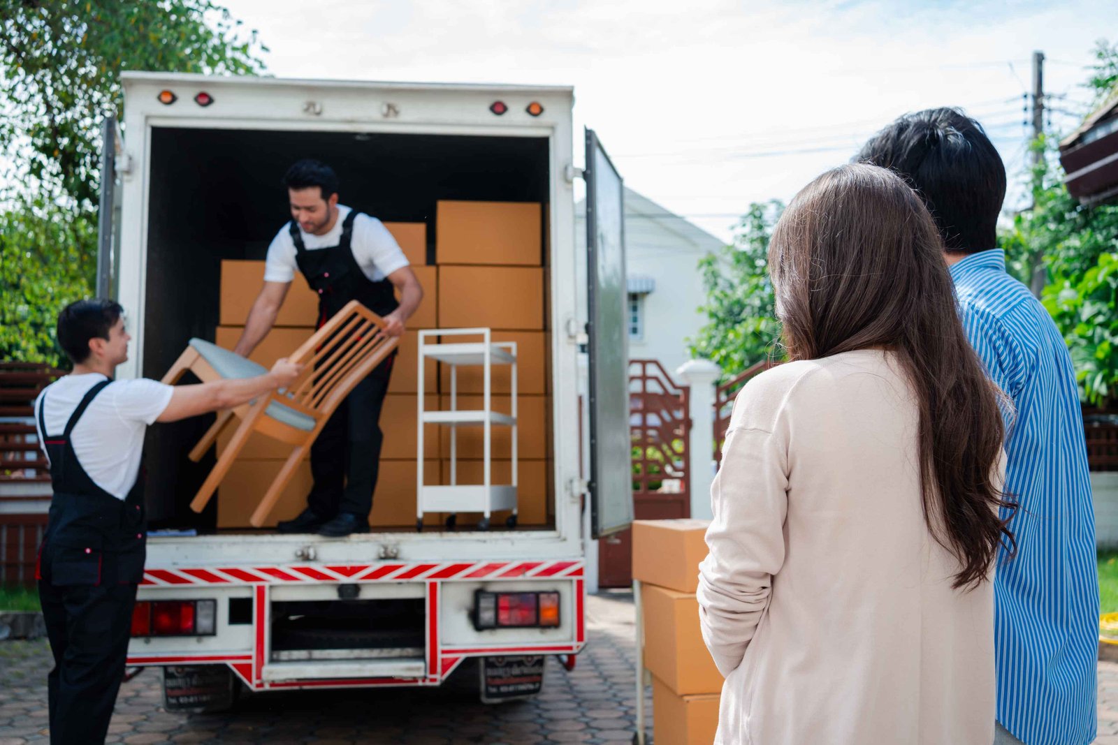 couple loading boxes in a truck to be carried to a storage unit at longley corners