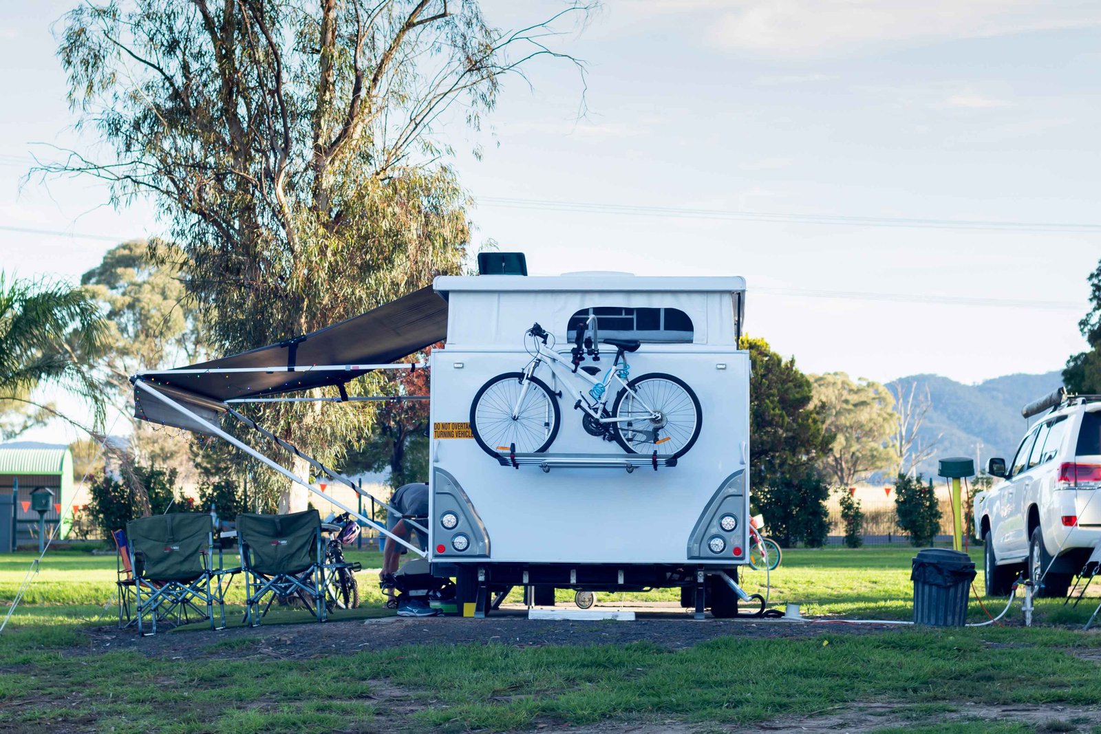 rv caravan with bike on the back camping